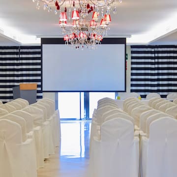 a room with chairs and chandelier