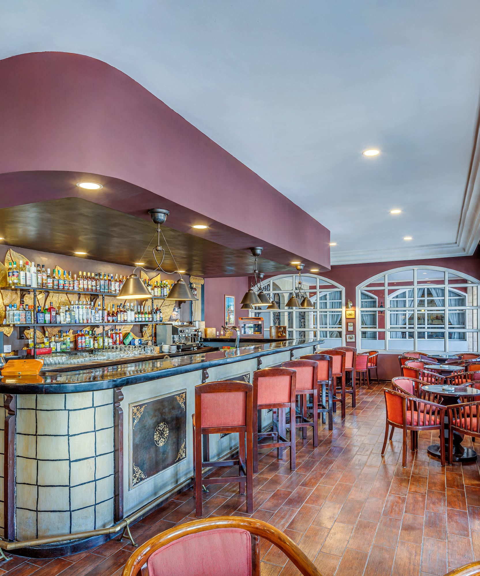 a bar with chairs and tables in a room