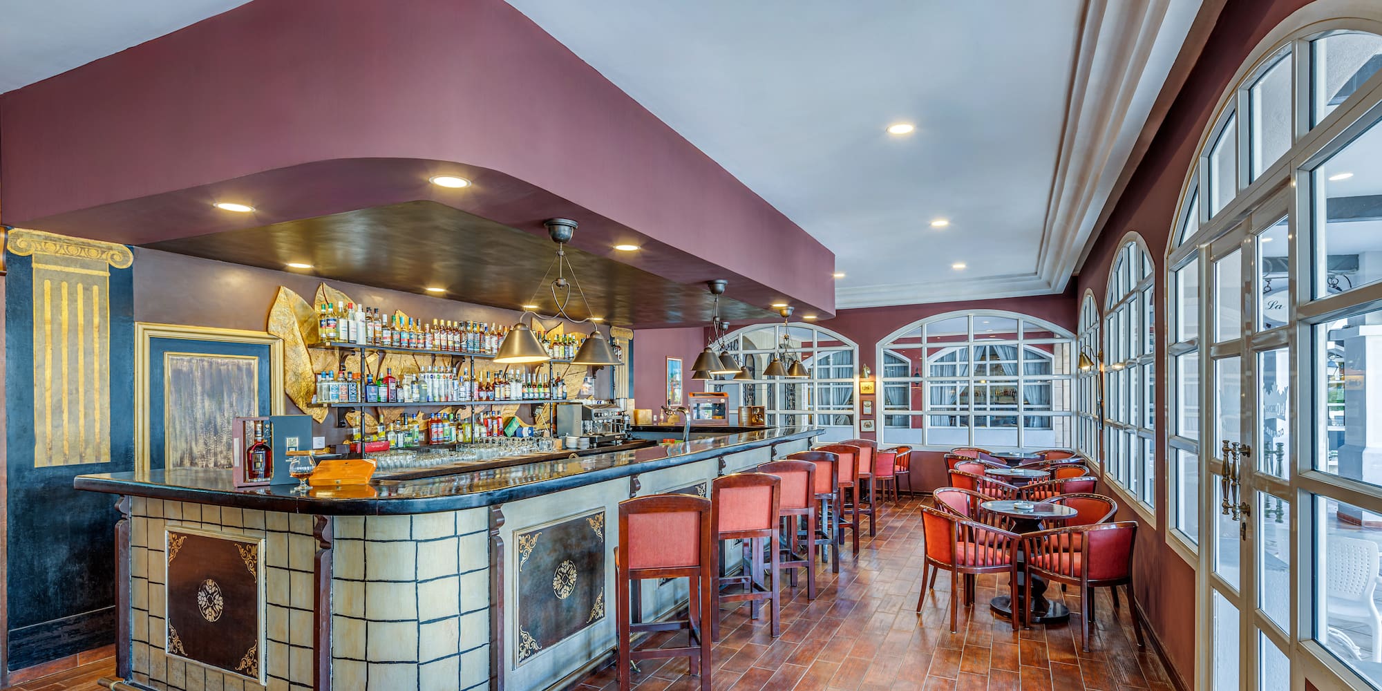 a bar with chairs and tables in a room