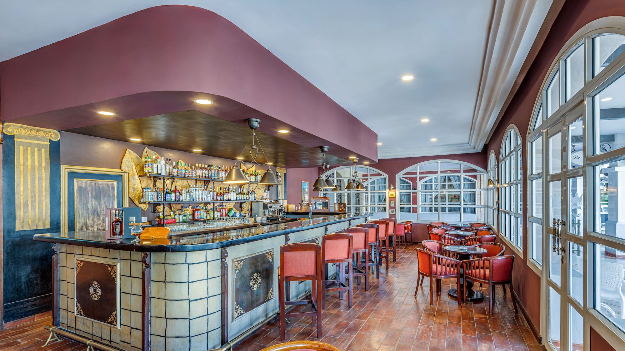 a bar with chairs and tables in a room