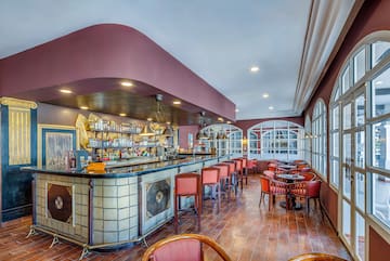 a bar with chairs and tables in a room