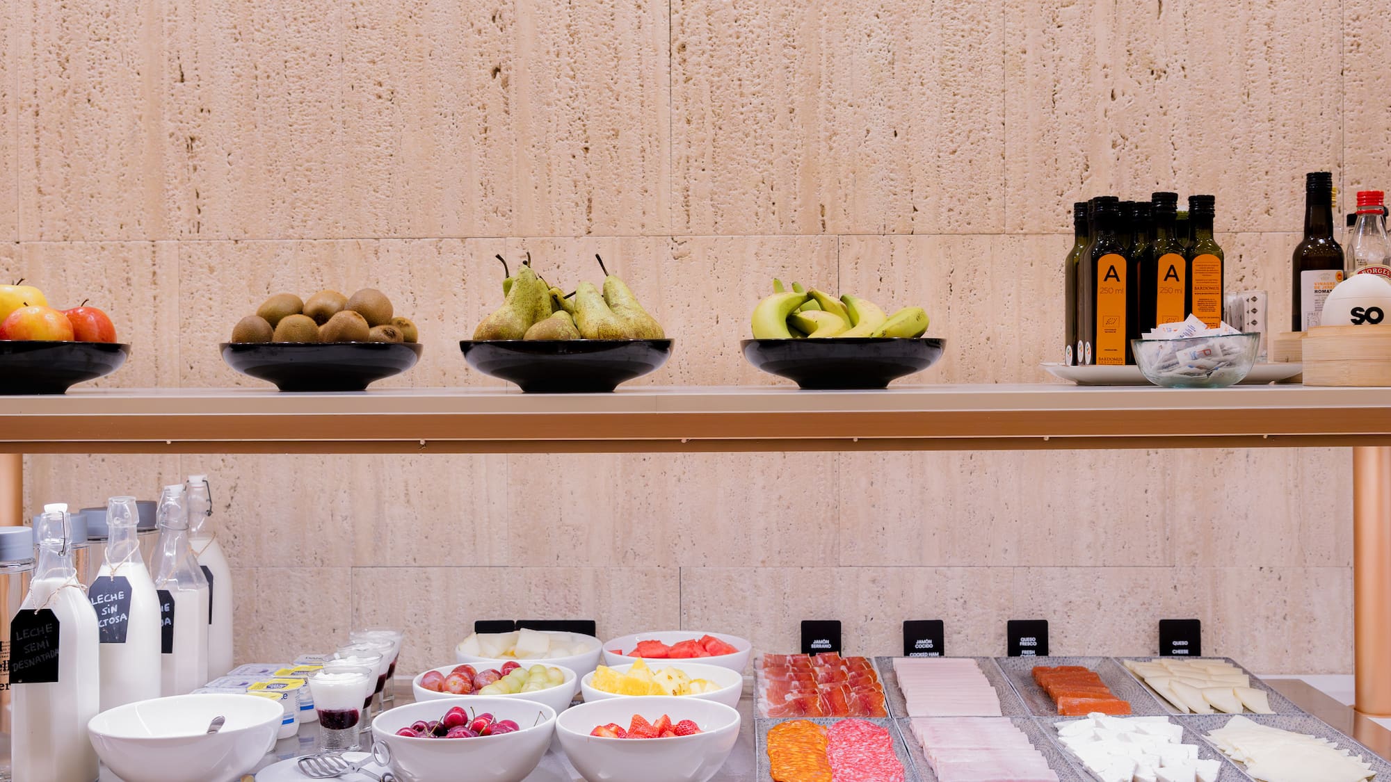 a shelf with bowls of fruit and other food on it