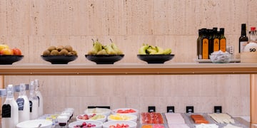 a shelf with bowls of fruit and other food on it