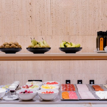 a shelf with bowls of fruit and other food on it