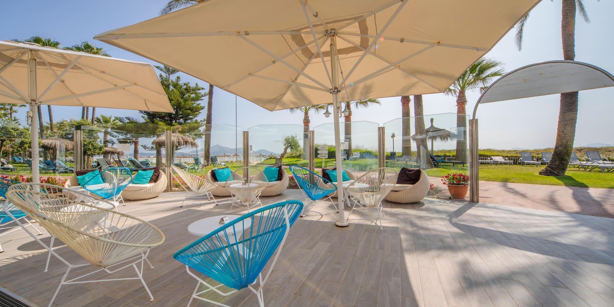a patio with chairs and umbrellas