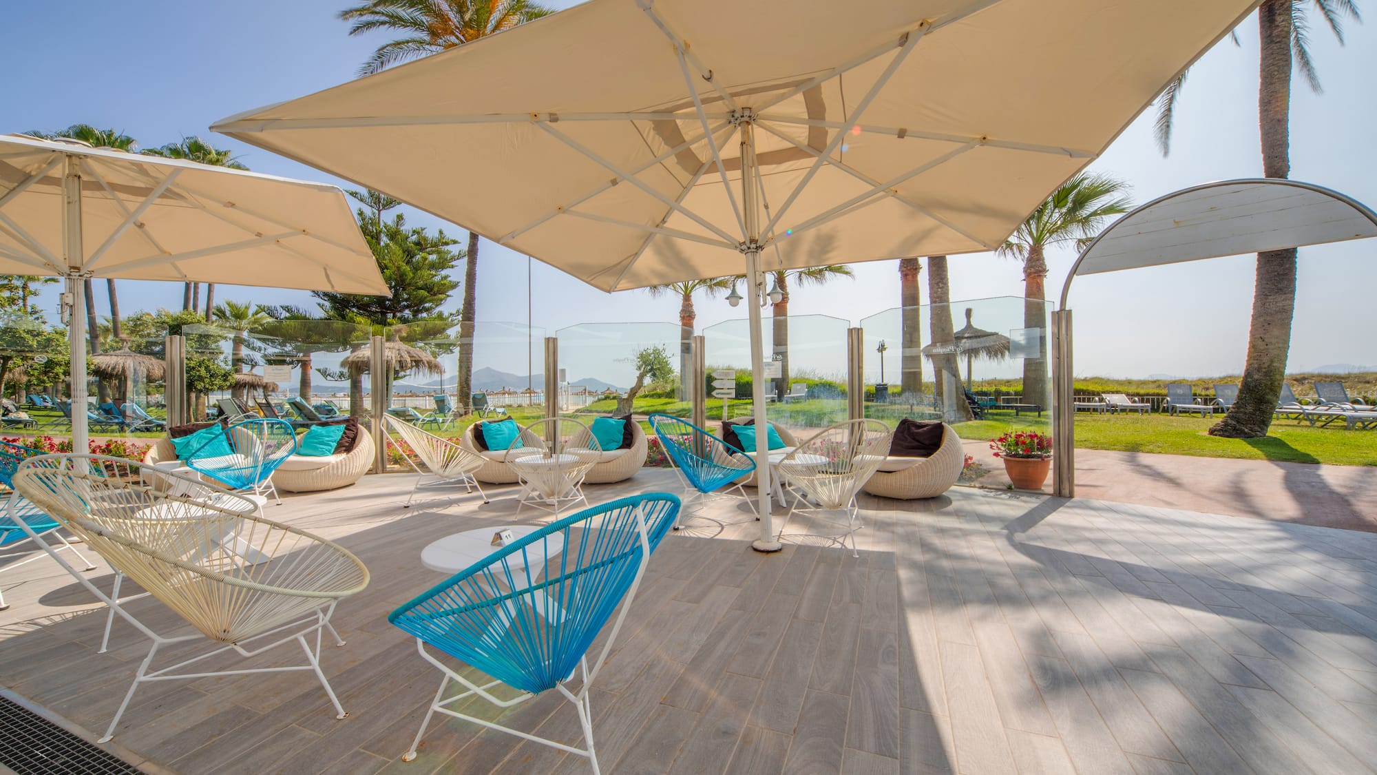 a patio with chairs and umbrellas