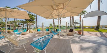 a patio with chairs and umbrellas