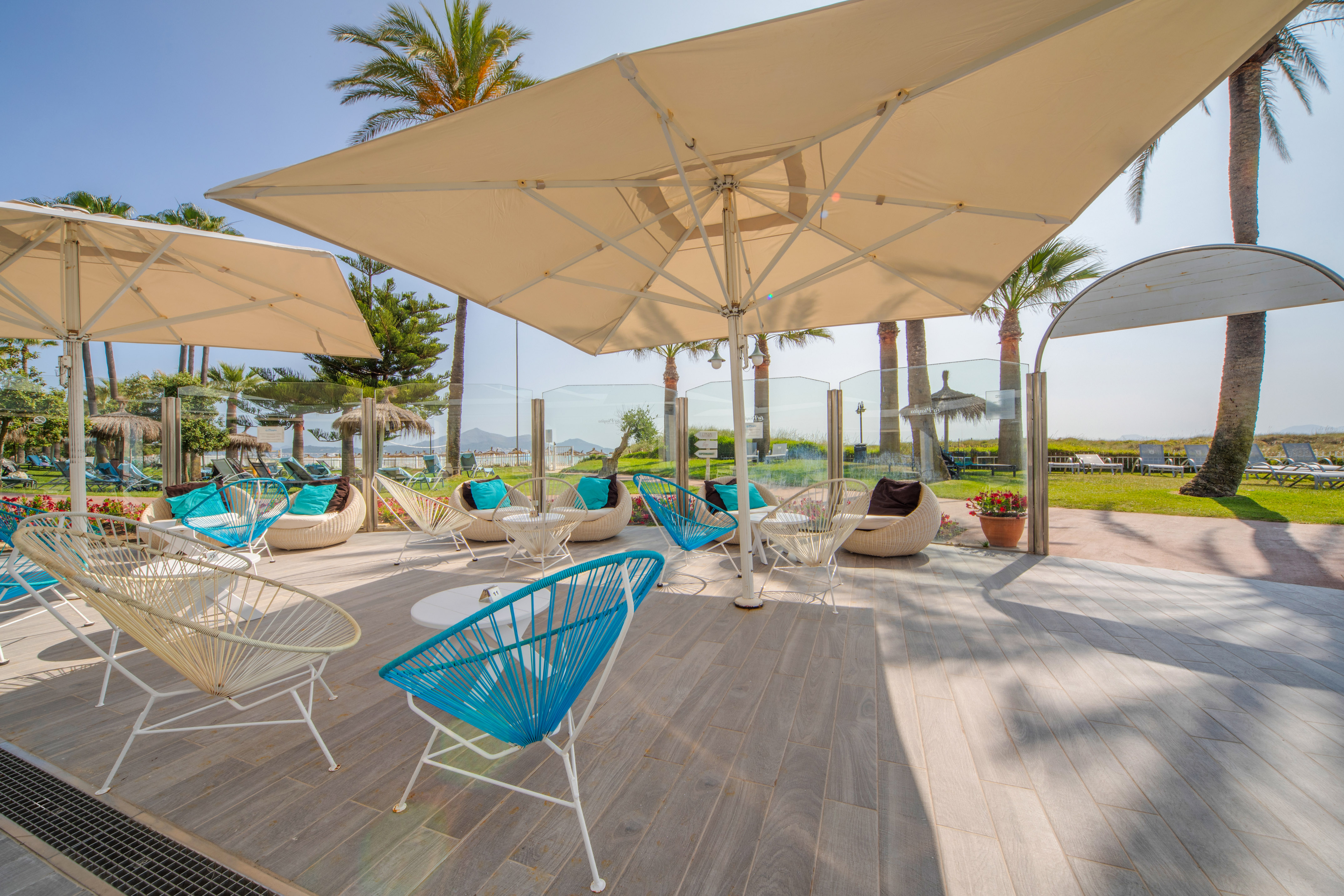 a patio with chairs and umbrellas