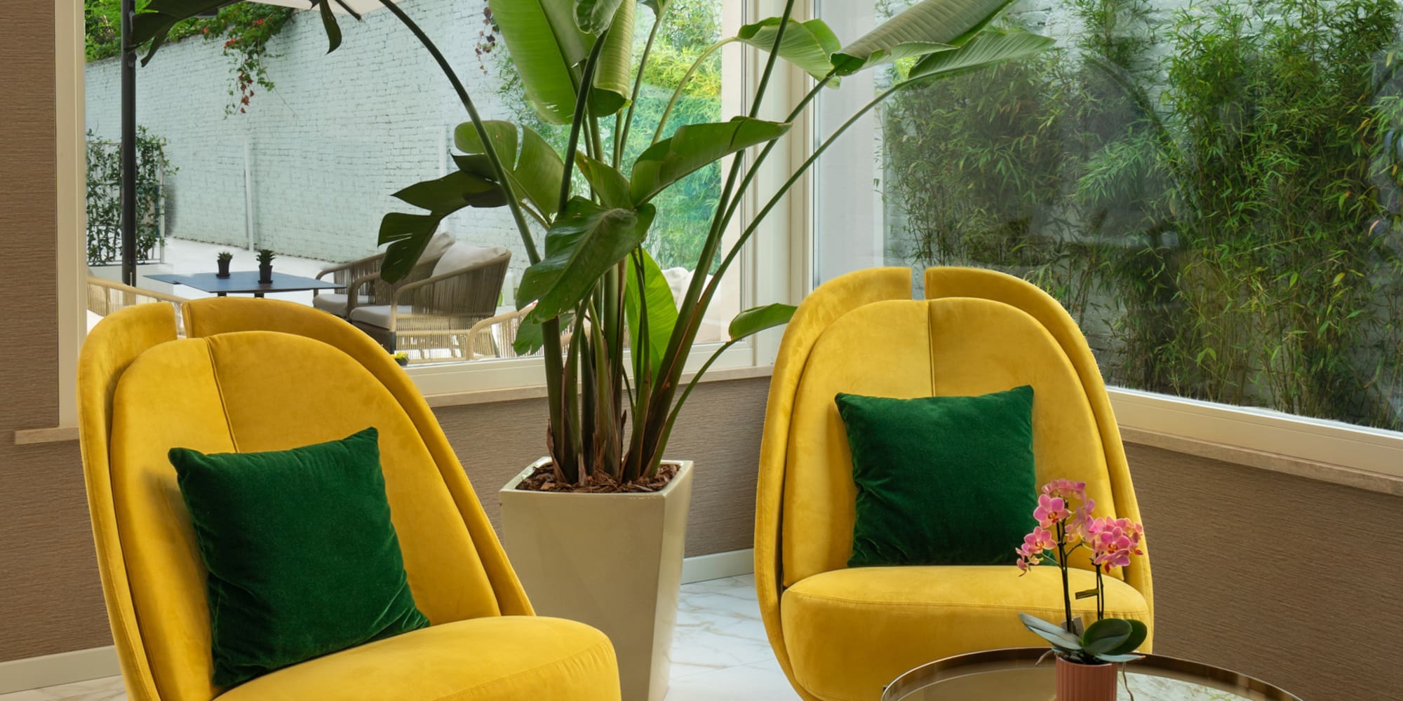 a yellow chairs and a table in a room with a large window