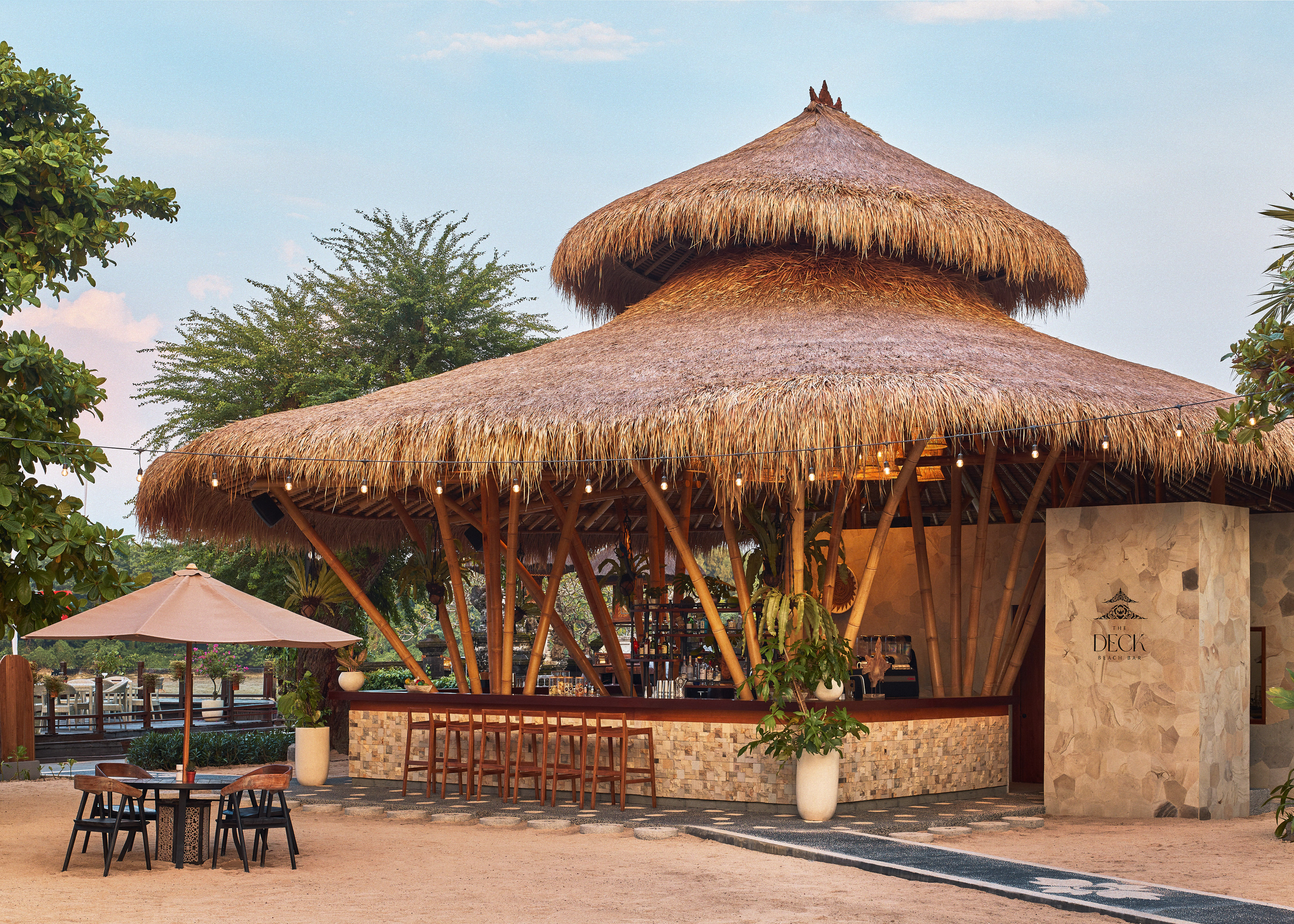 The Deck beach bar: thatched roof, bamboo structure, outdoor seating.