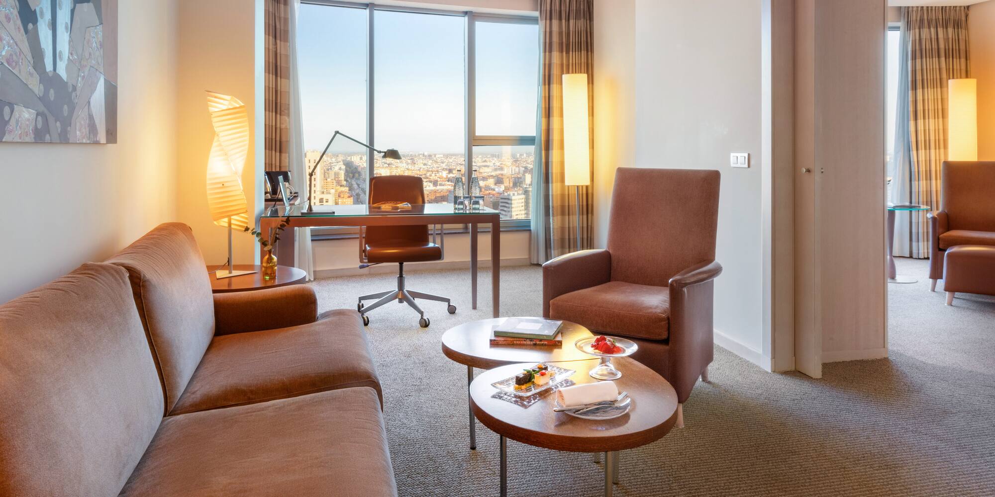 a room with a desk and chairs