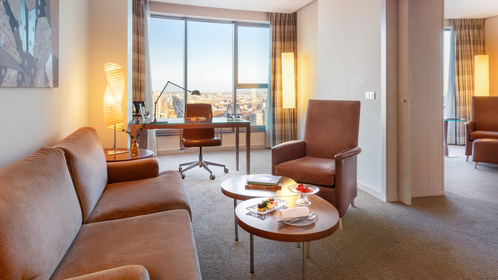 a room with a desk and chairs