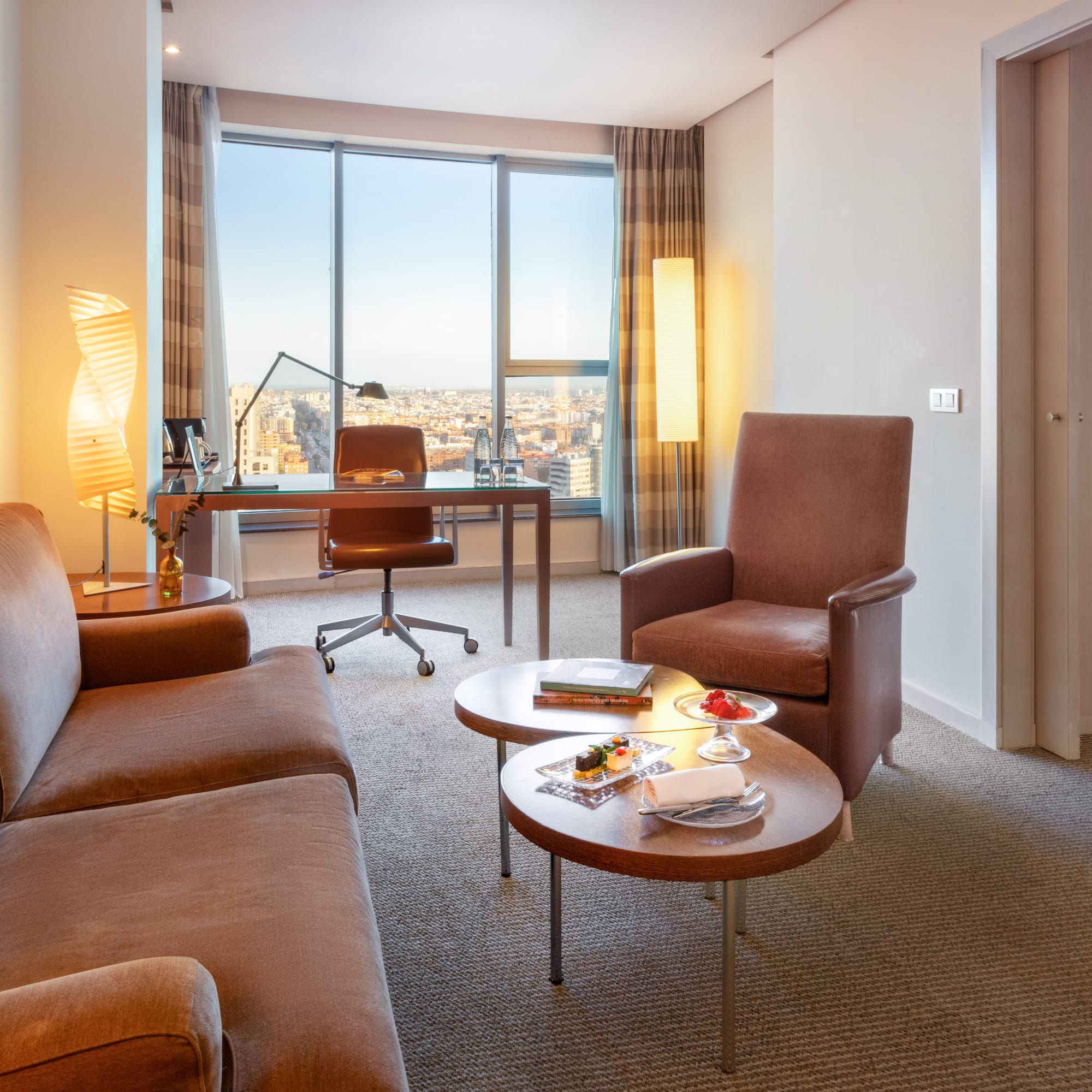 a room with a desk and chairs