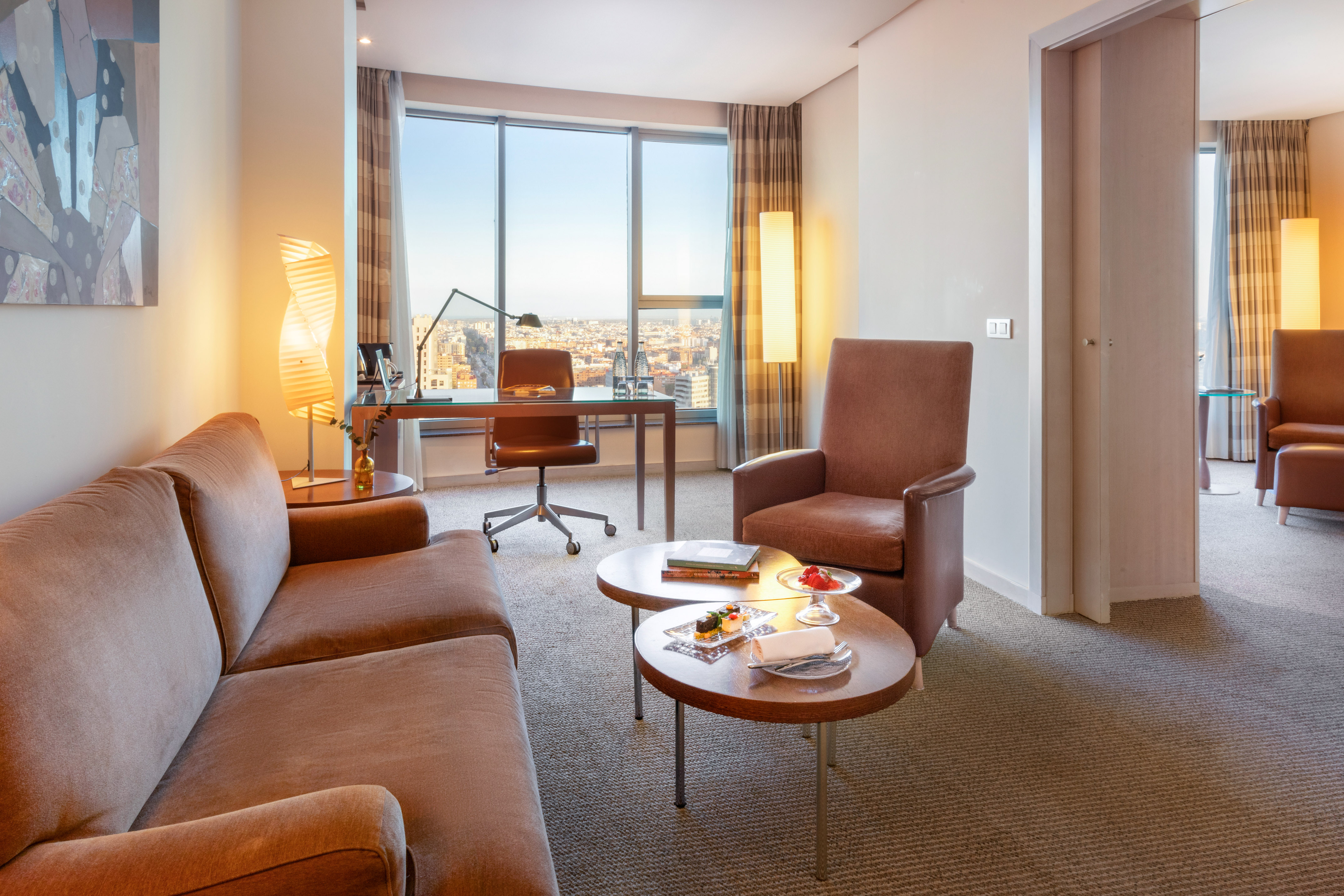 a room with a desk and chairs