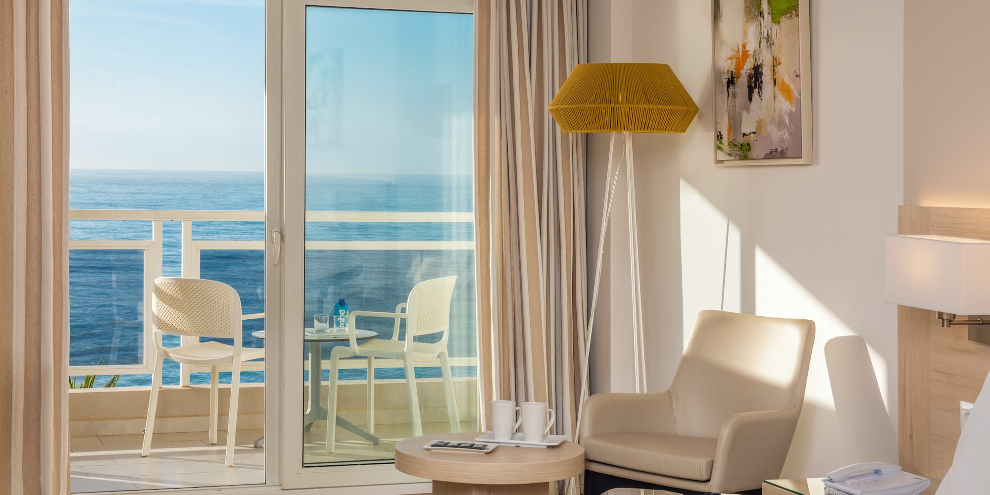 a room with a glass door and a table and chairs