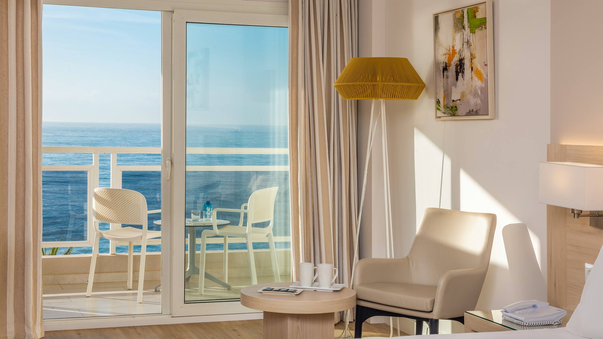 a room with a glass door and a table and chairs