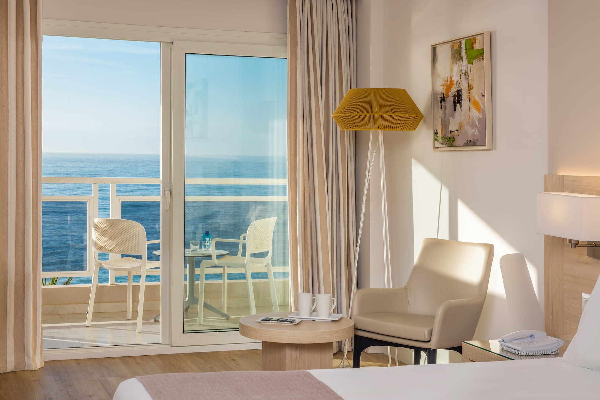a room with a glass door and a table and chairs