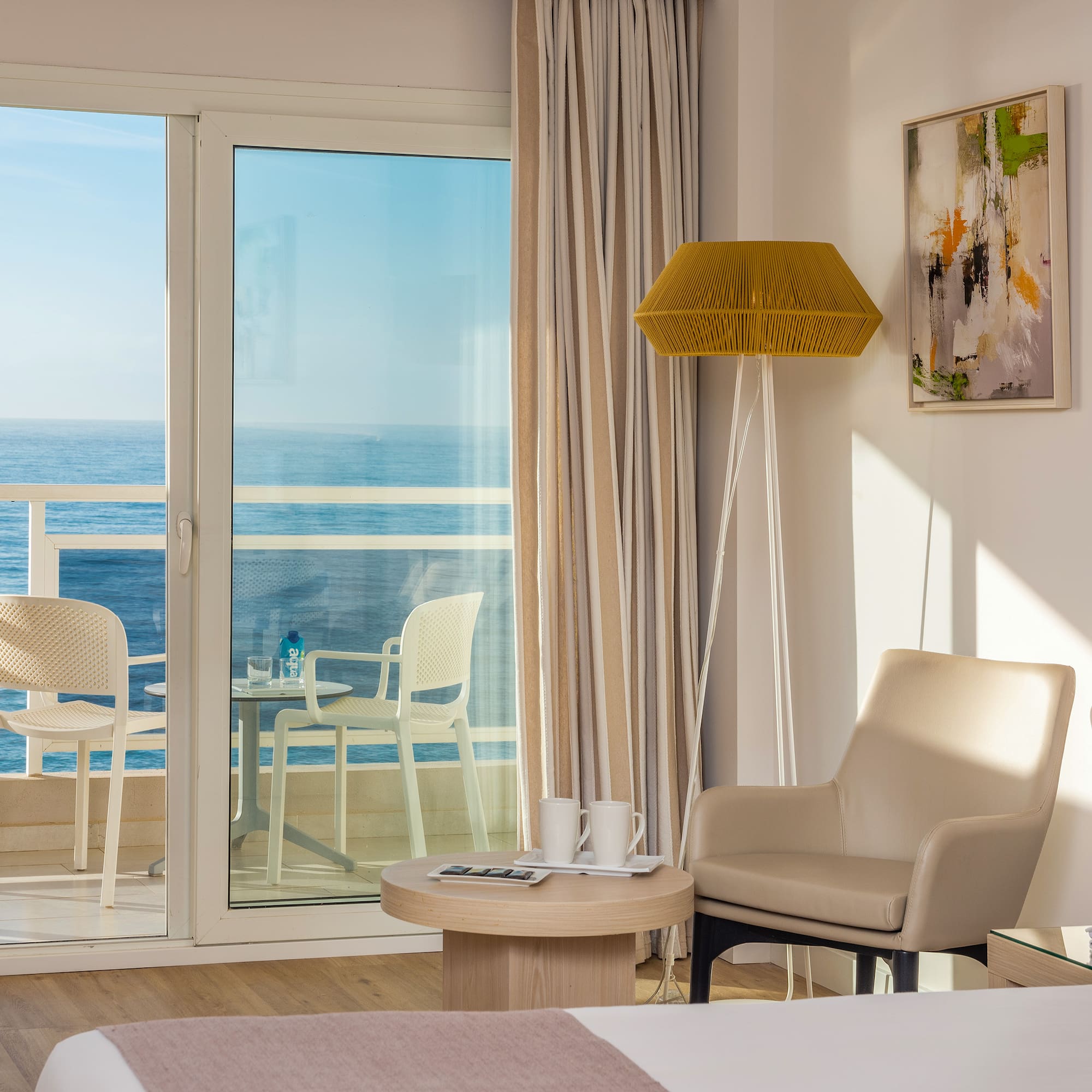 a room with a glass door and a table and chairs