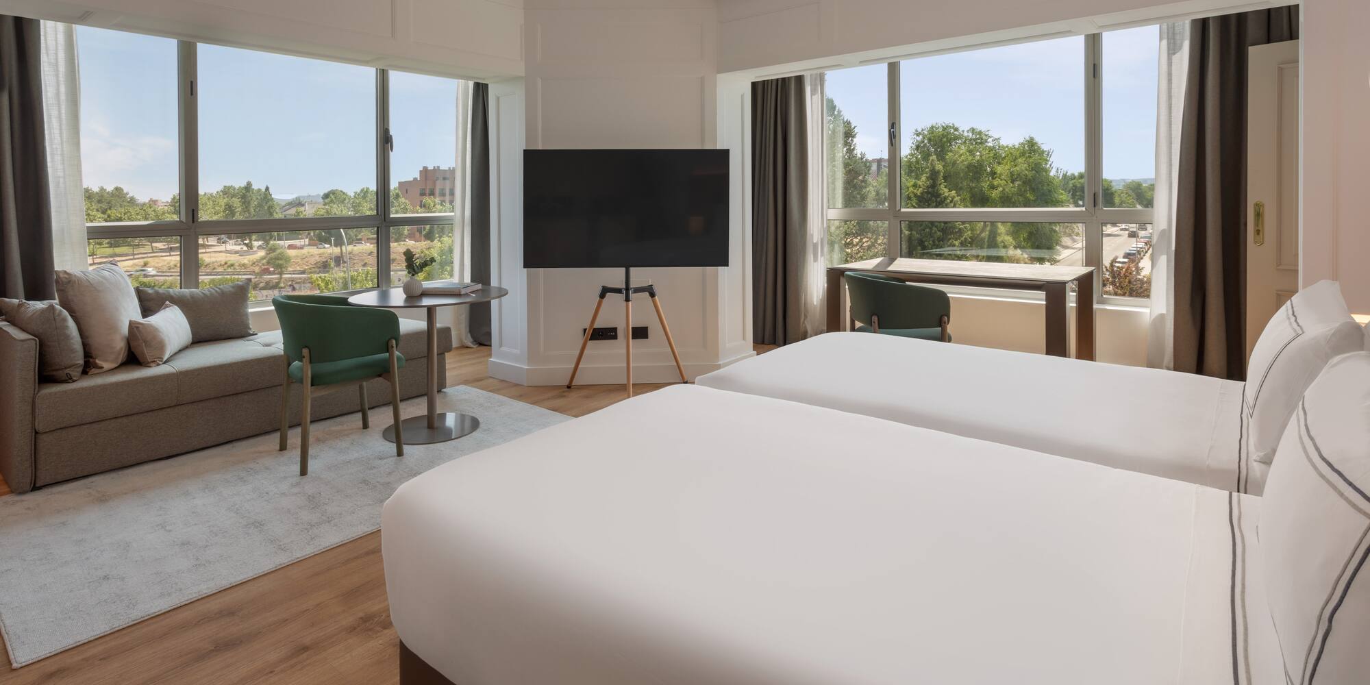 a room with two beds and a television