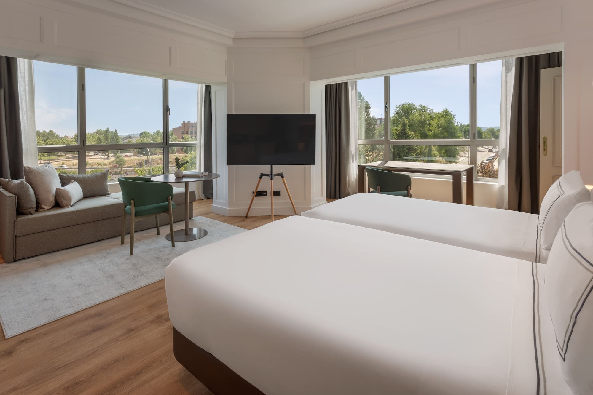 a room with two beds and a television