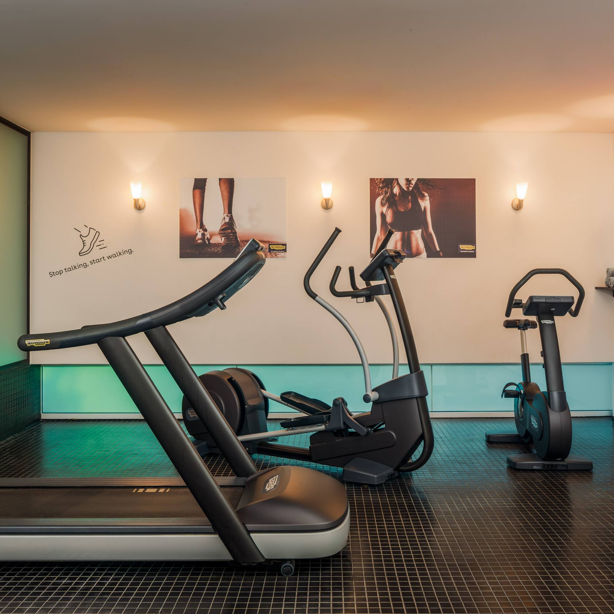 a room with exercise machines and a white board