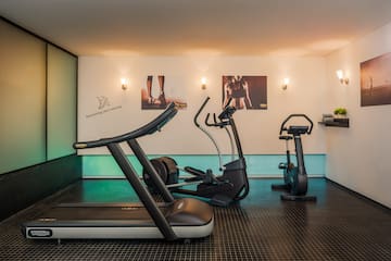 a room with exercise machines and a white board
