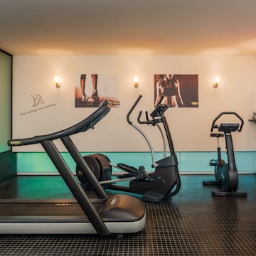 a room with exercise machines and a white board