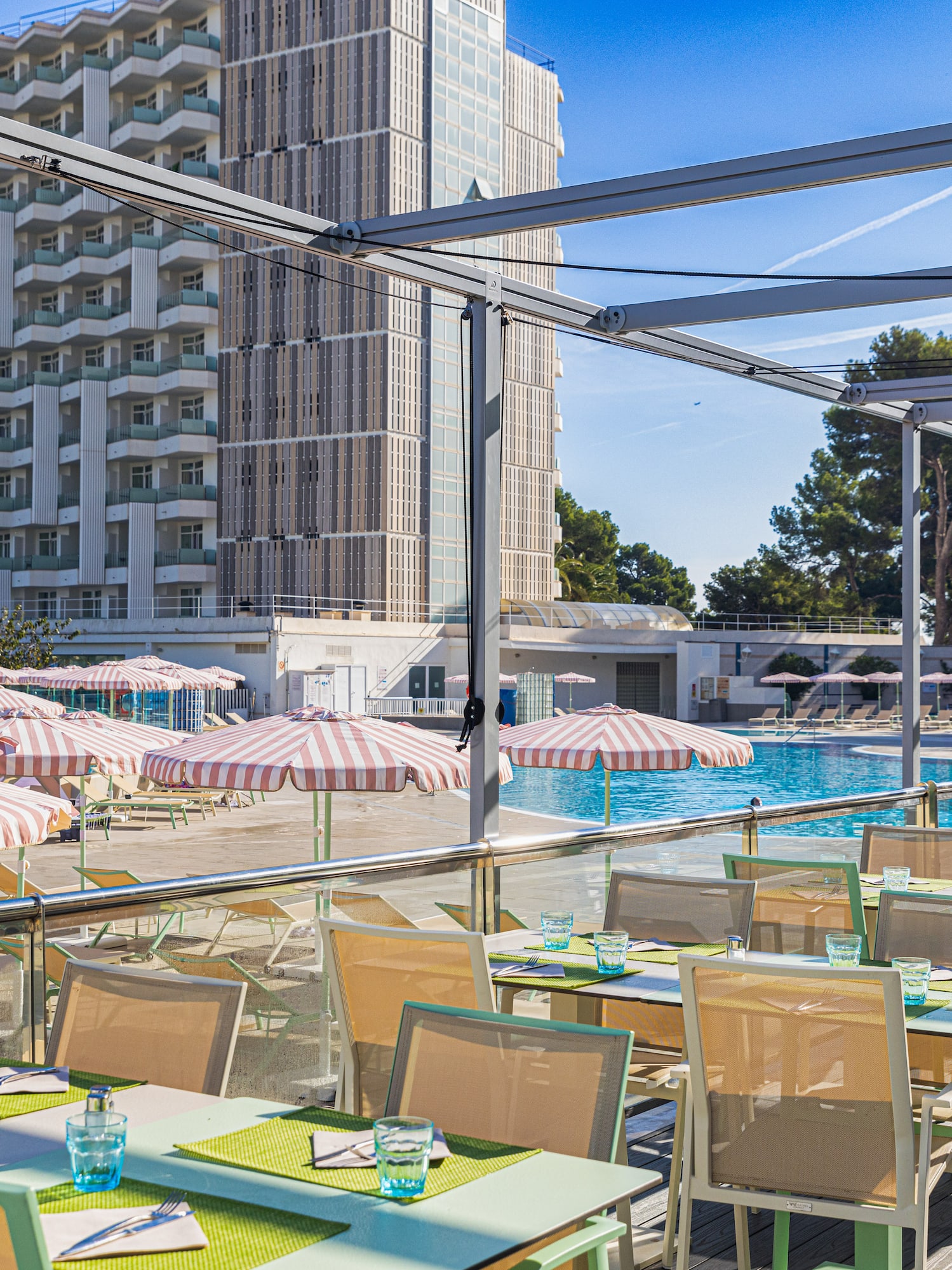 a pool with tables and chairs