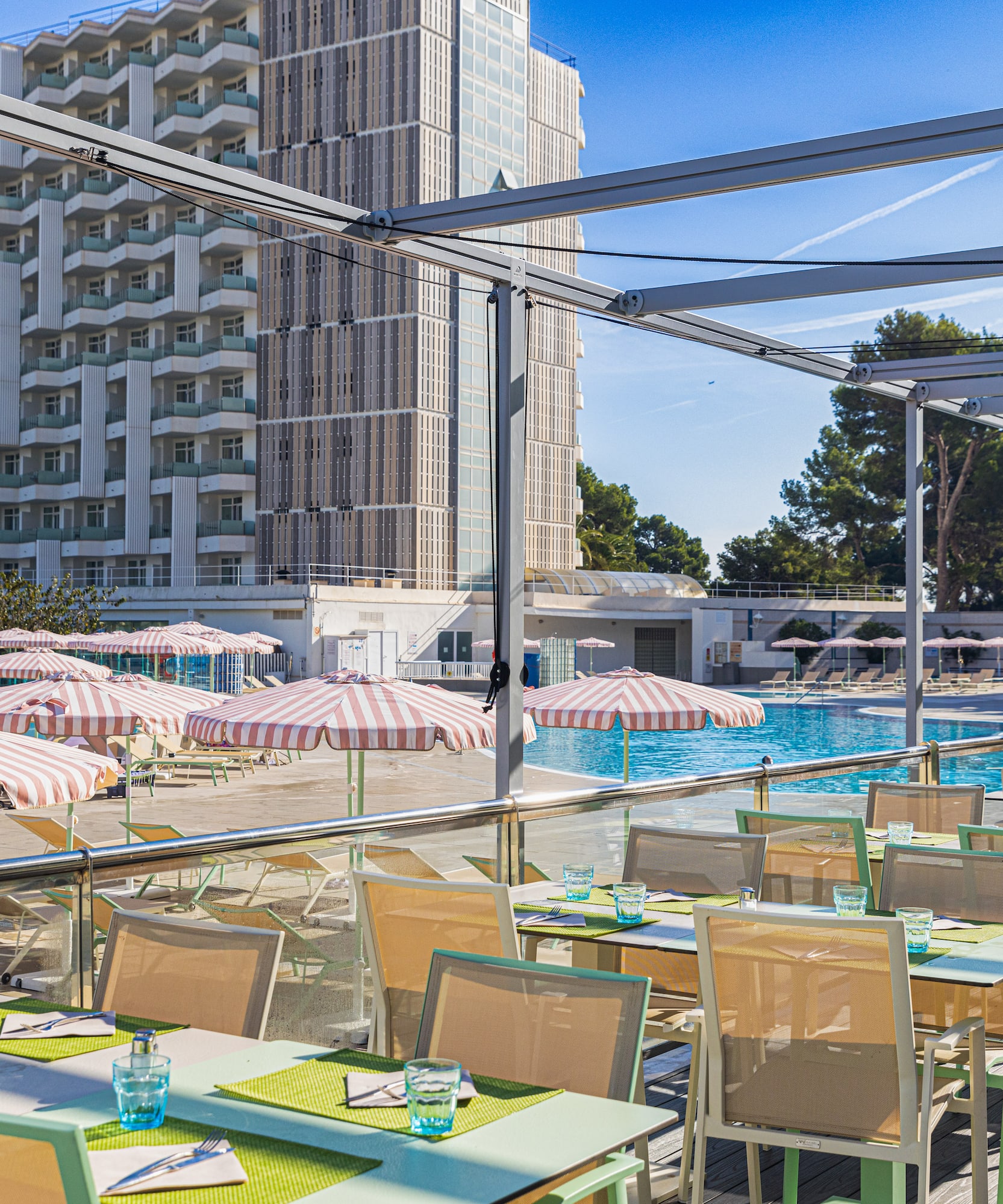 a pool with tables and chairs