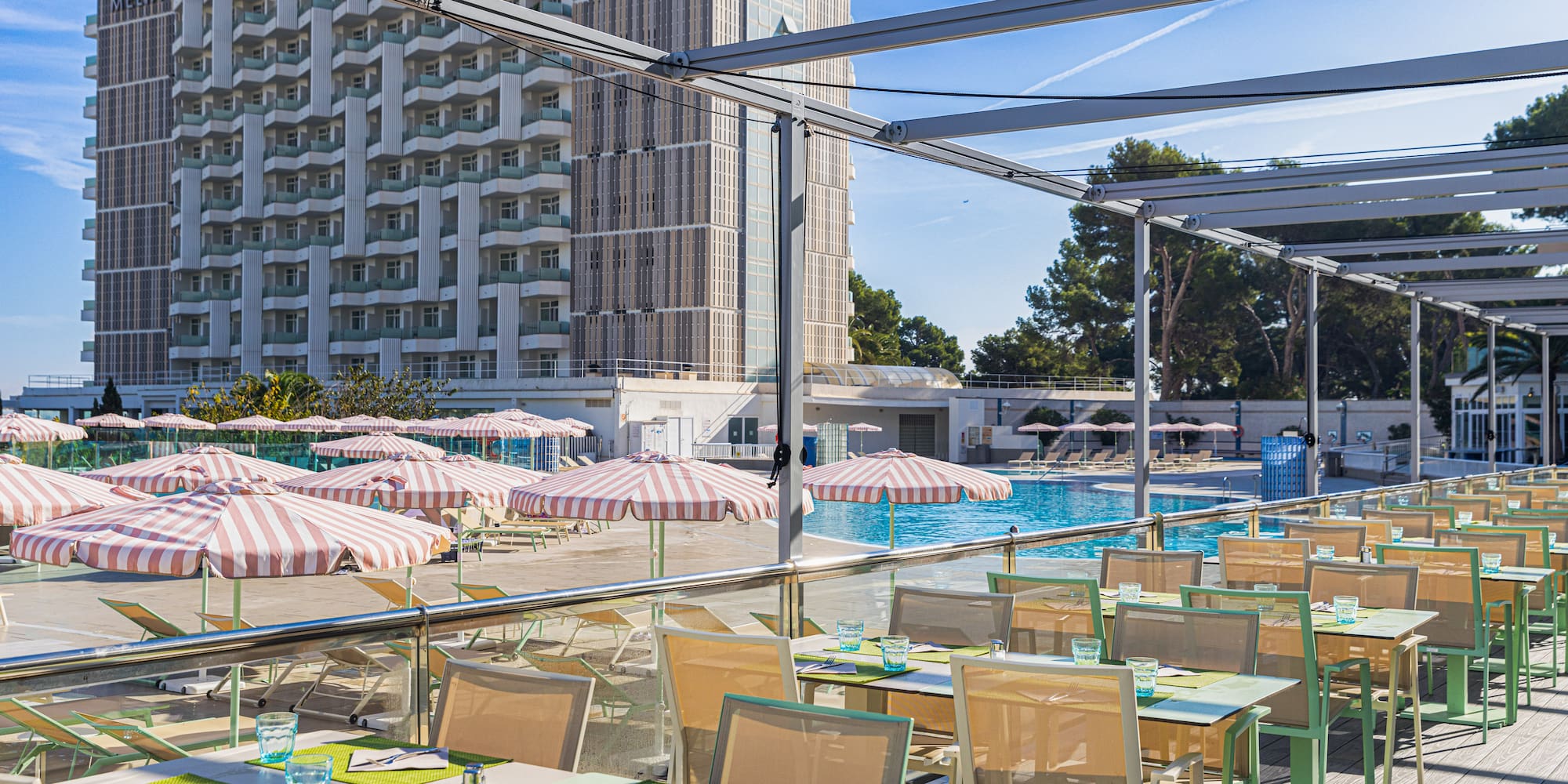 a pool with tables and chairs