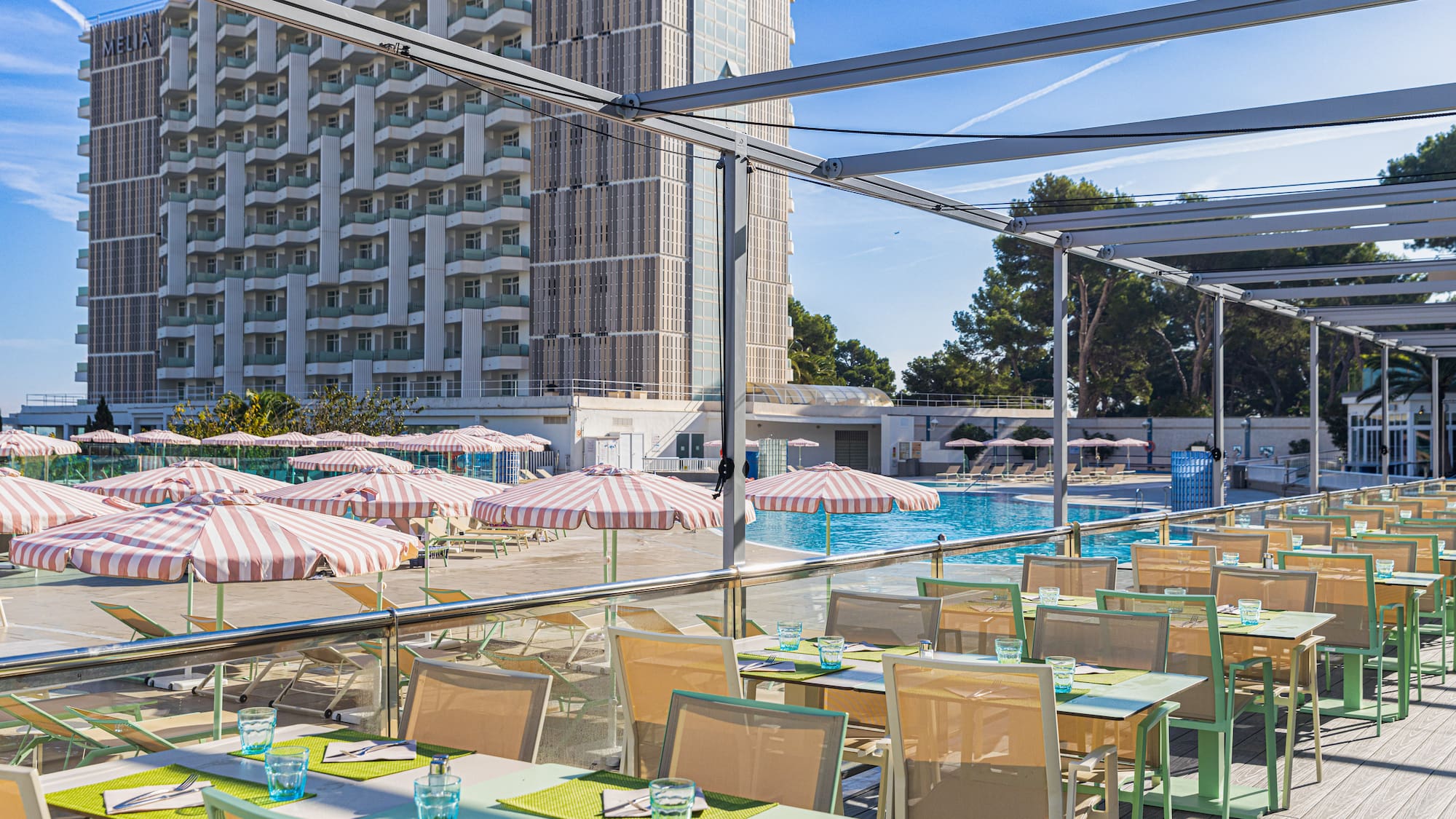 a pool with tables and chairs