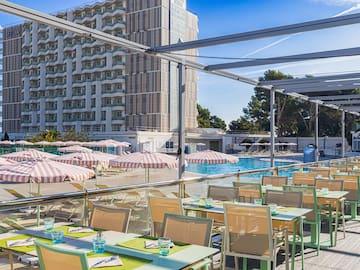 a pool with tables and chairs