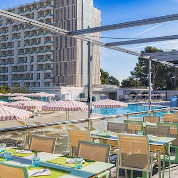 a pool with tables and chairs