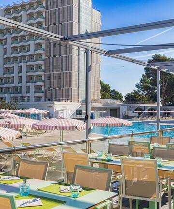 a pool with tables and chairs