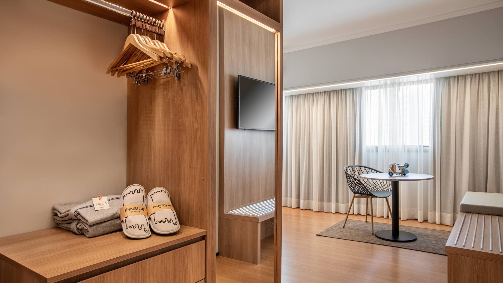 a room with a closet and a tv