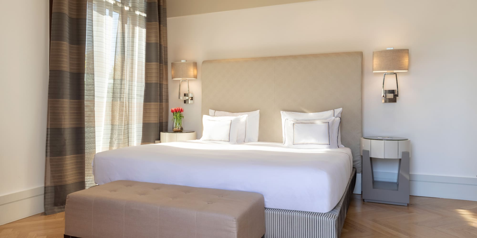 a bed with a bench in a room