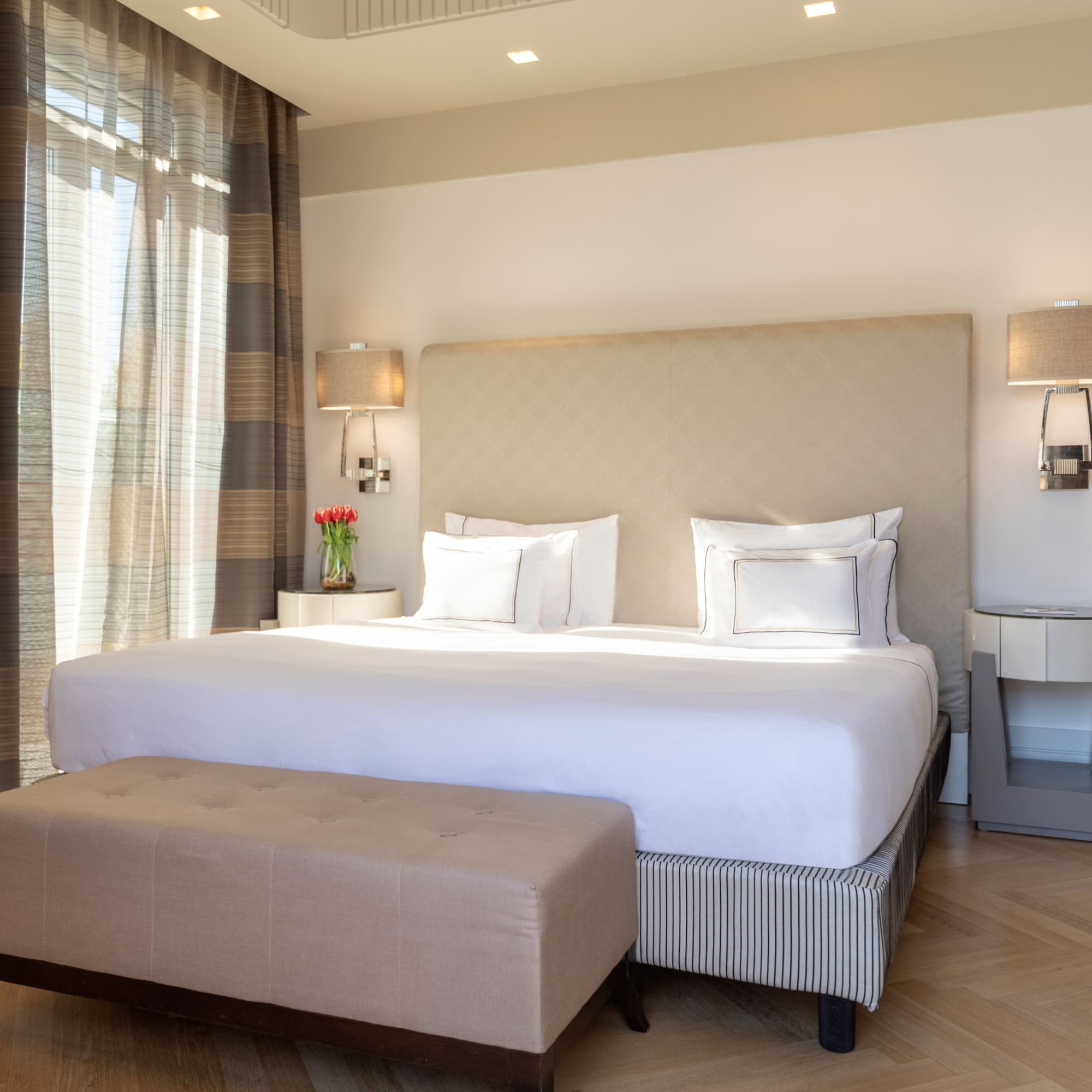 a bed with a bench in a room