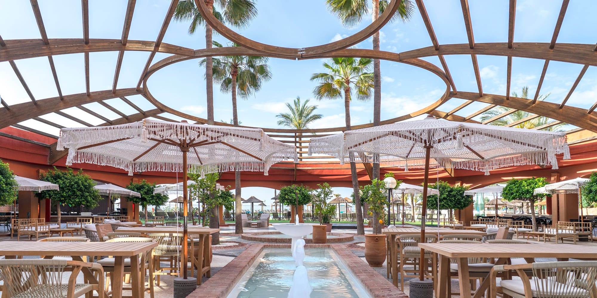 a patio with tables and umbrellas