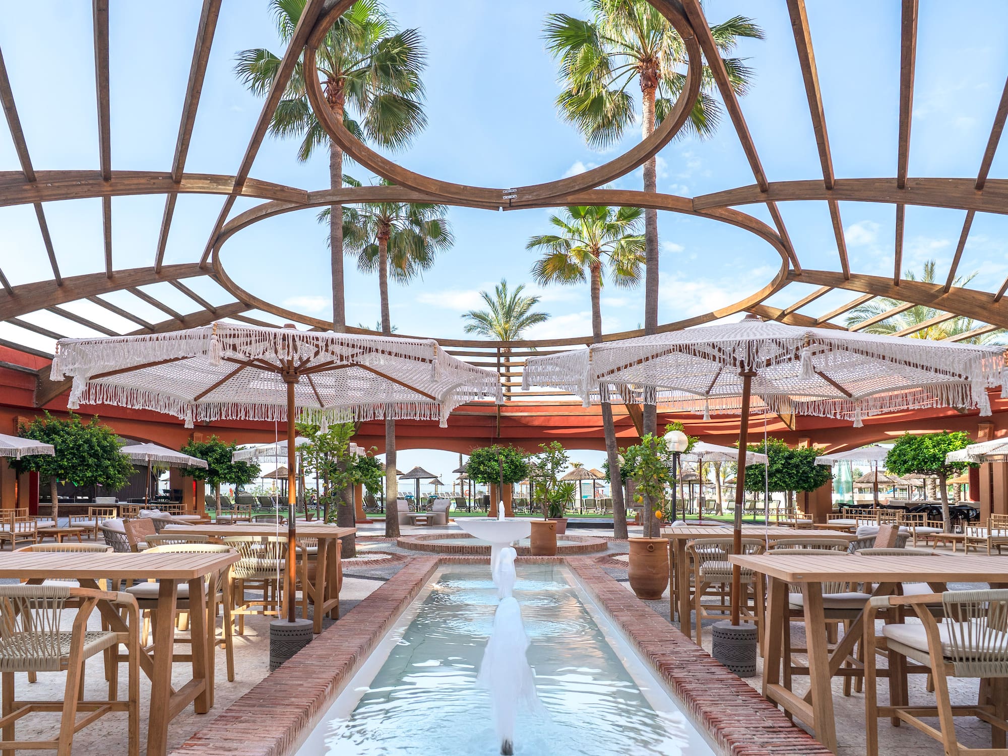 a patio with tables and umbrellas