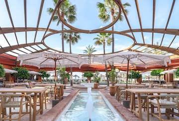 a patio with tables and umbrellas