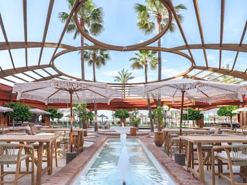 a patio with tables and umbrellas