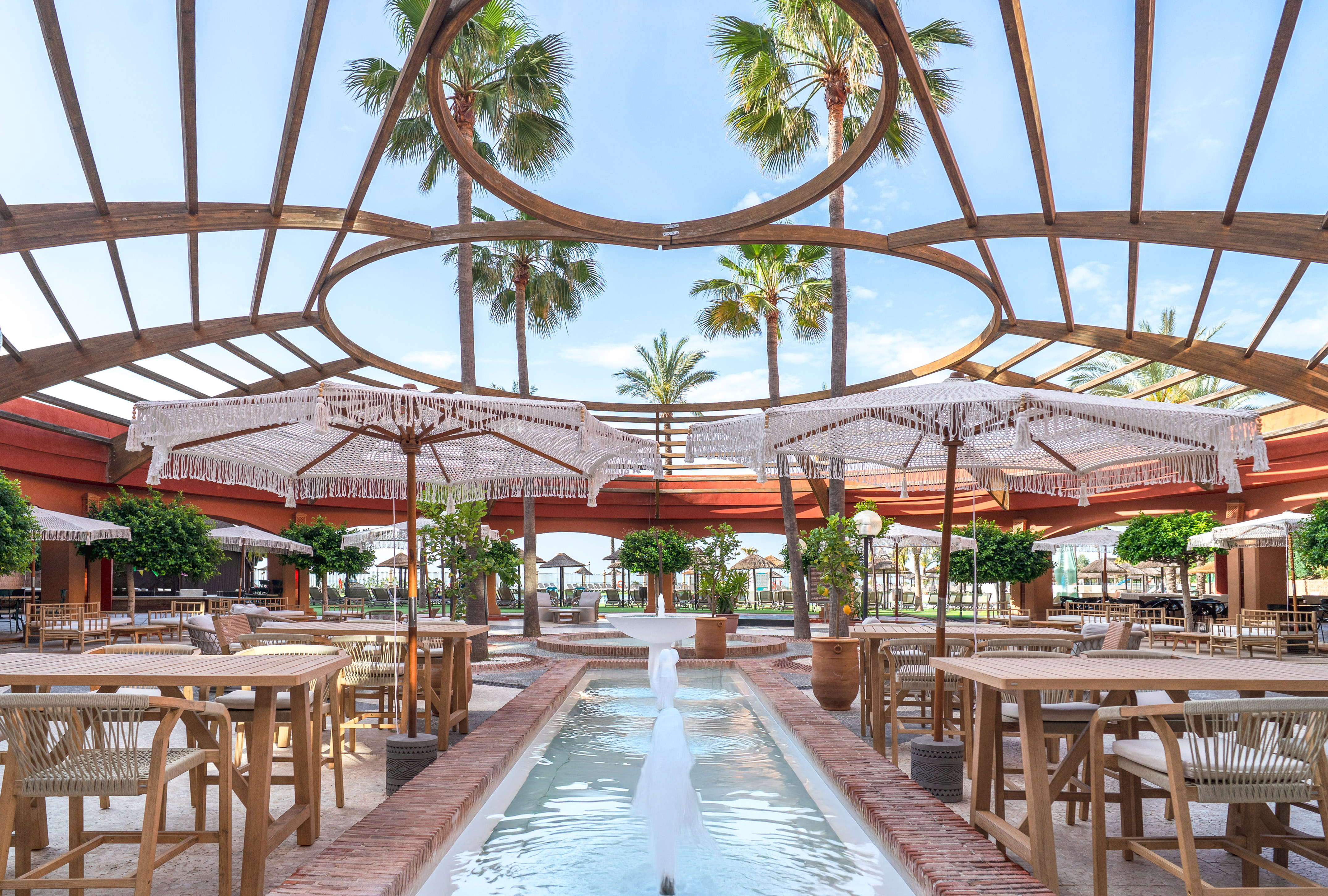 a patio with tables and umbrellas