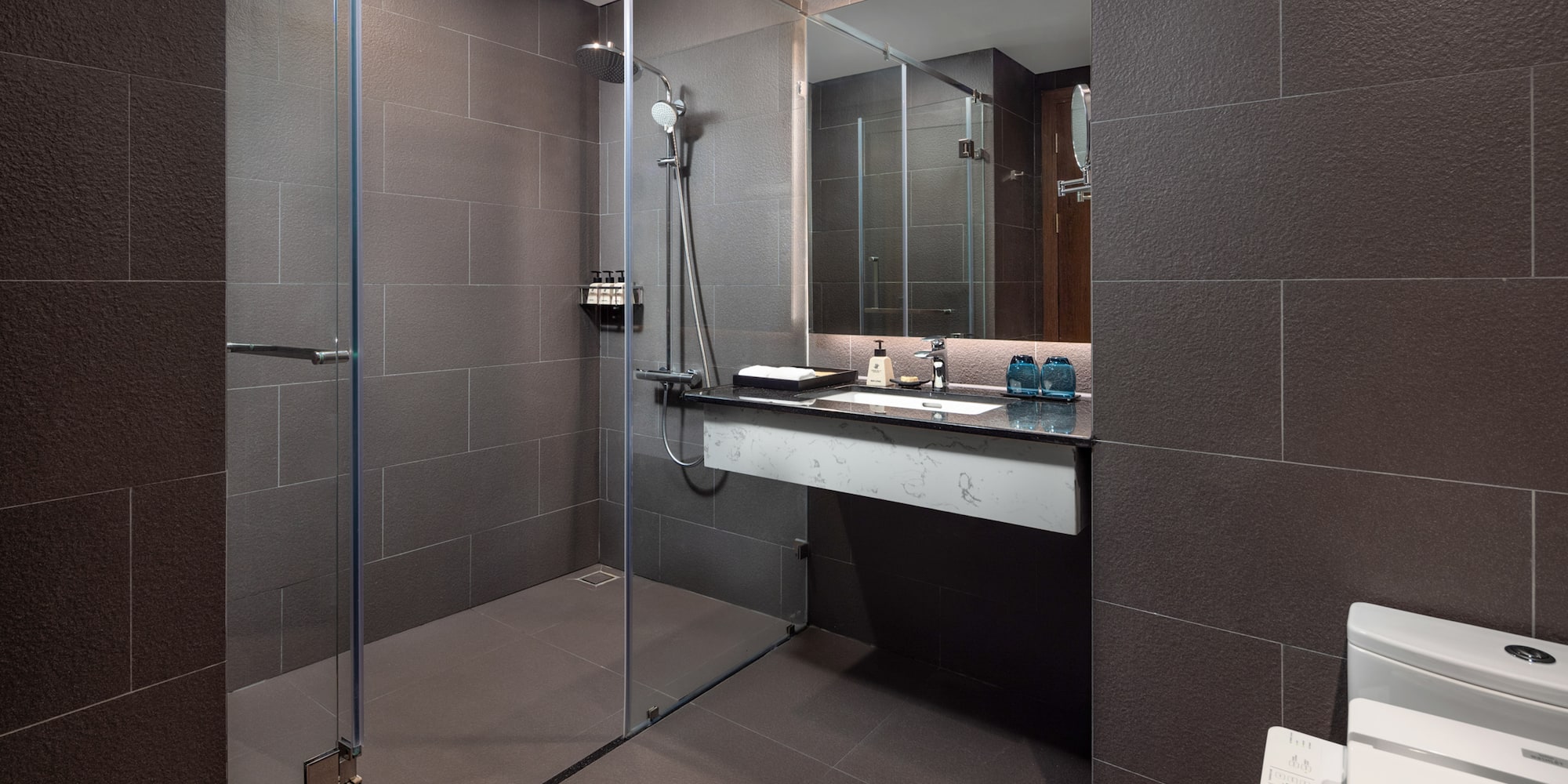 a bathroom with a glass shower and sink