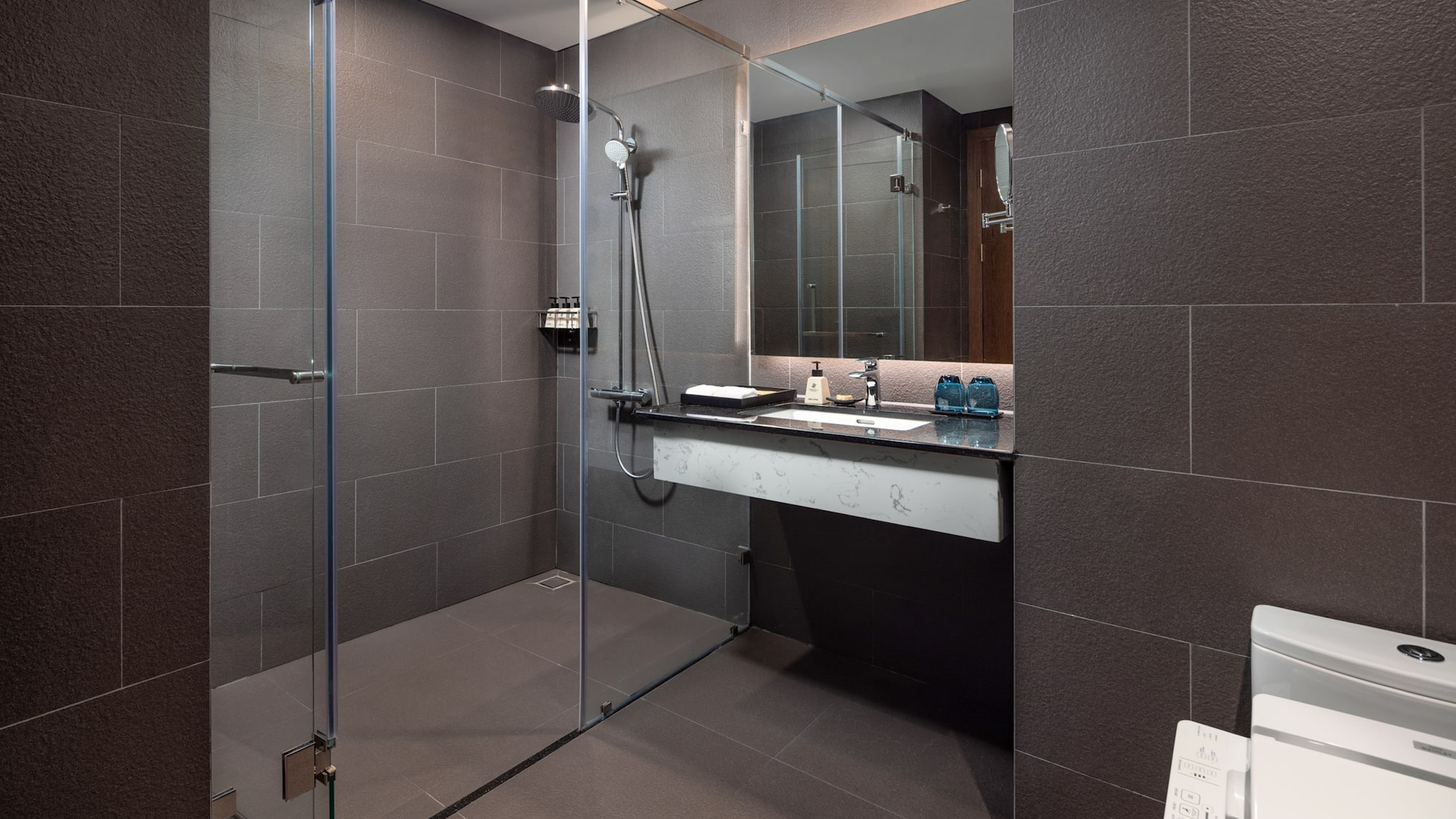 a bathroom with a glass shower and sink