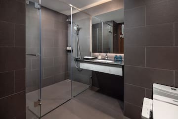 a bathroom with a glass shower and sink