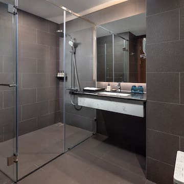 a bathroom with a glass shower and sink