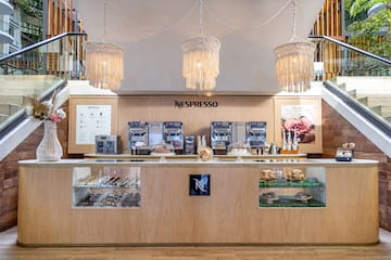 a coffee shop with a counter and chandeliers