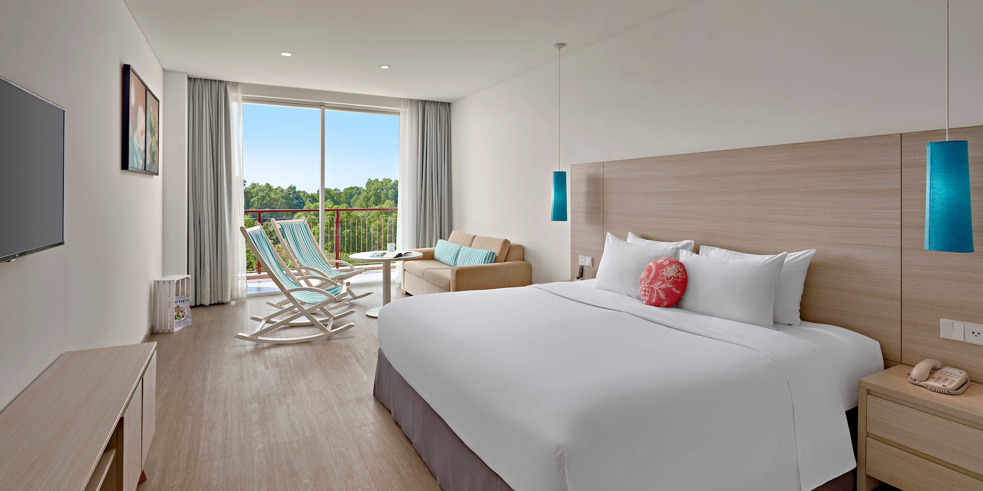 a room with a bed and chairs