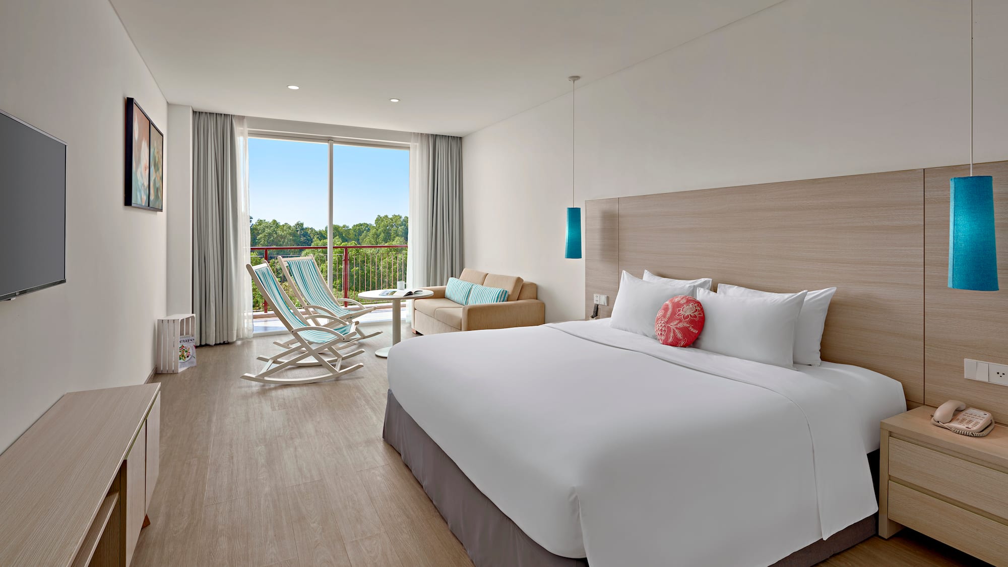 a room with a bed and chairs