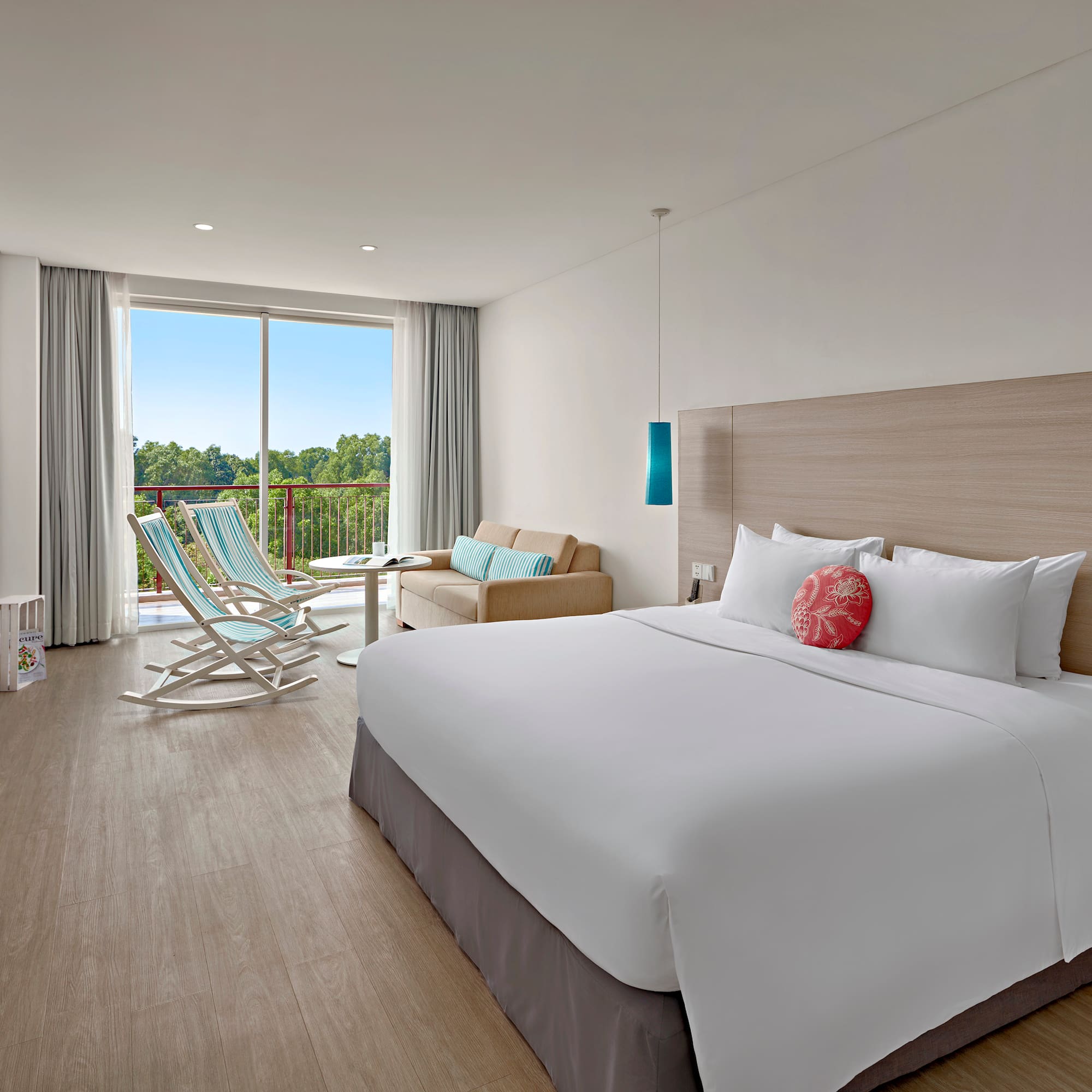 a room with a bed and chairs